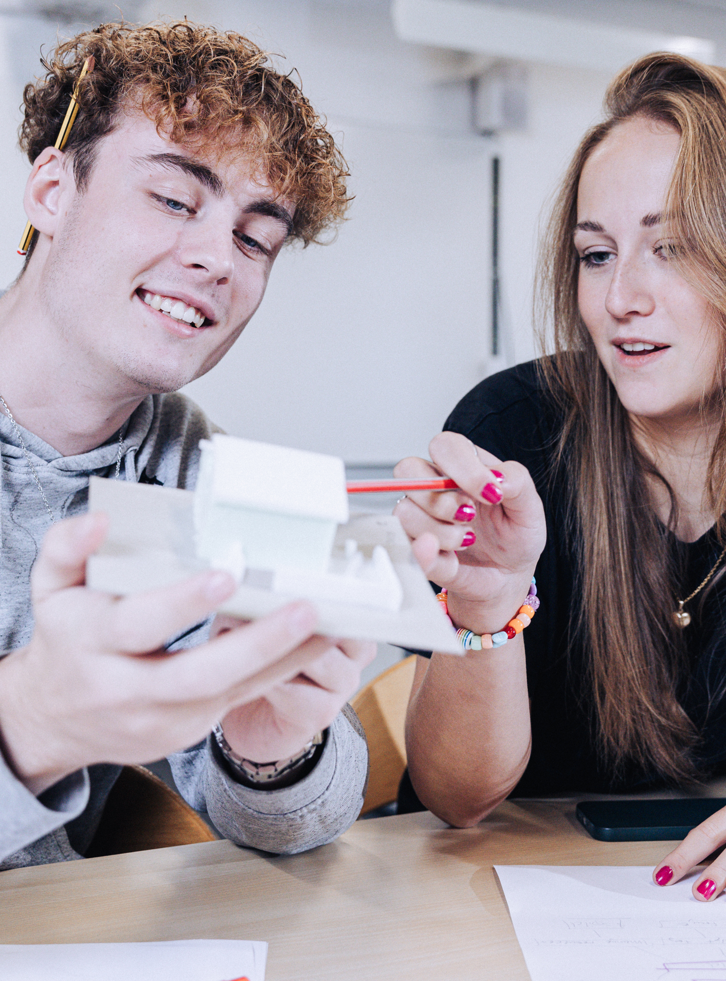 Innovation og teknologi, elever sidder med model af et hus